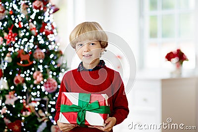 Kids decorate Christmas tree. Child on Xmas eve Stock Photo