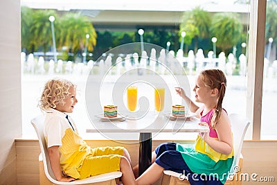 Kids eat cake at restaurant. Boy and girl in cafe. Stock Photo