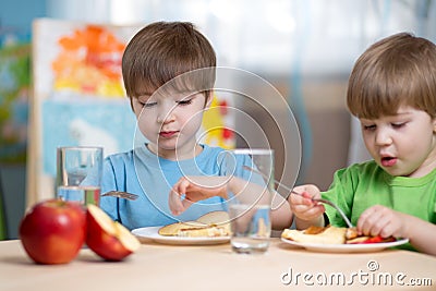 Kids eating healthy food at home Stock Photo