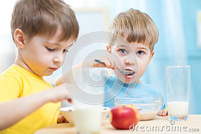 Kids eating healthy food at home or kindergarten Stock Photo