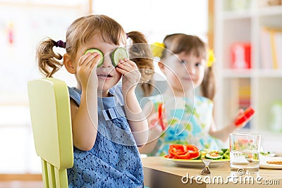 Kids eating healthy food in kindergarten or at home Stock Photo