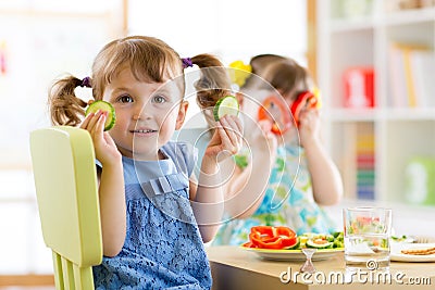 Kids eating healthy food in kindergarten or at home Stock Photo