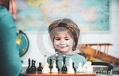 Kids educational games, early development. Young kid boy playing chess and having fun. Stock Photo