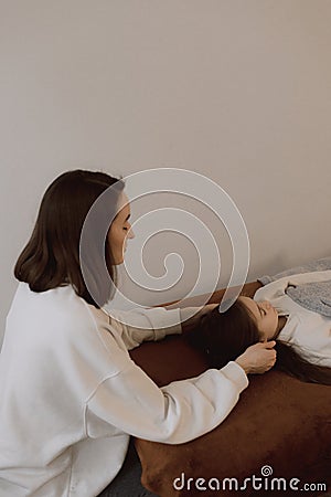 Female energy massage relaxing and care treatment for body and mindfull health gentle woman arms holding head doing access bars Stock Photo