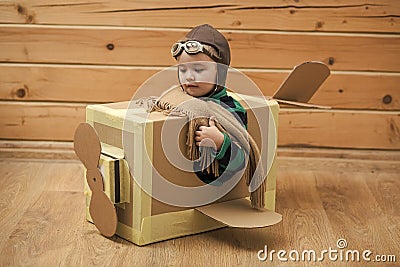 Kids enyoj happy day. Brave dreamer boy playing with a cardboard airplane Stock Photo