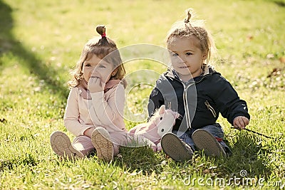 Kids enyoj happy day. Sister and brother play with toy horse on sunny day Stock Photo