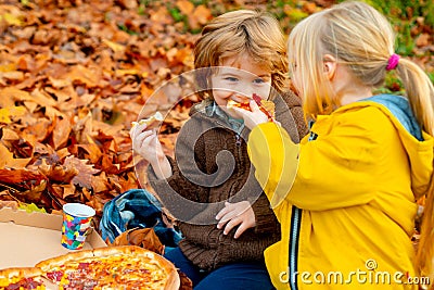 Kids favorite food. Children food concept, two happy hungry kids eating pizza. Stock Photo