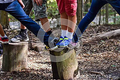 Kids feet on a tree stump during a game Stock Photo