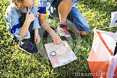 Kids finding direction on a map Stock Photo