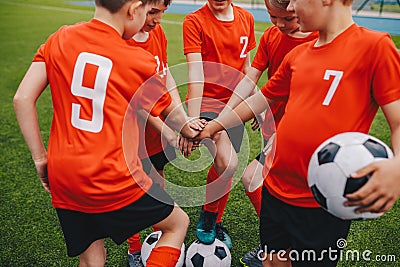Kids on Football Soccer Team Putting Hands in. Boys Football School Team Huddling Stock Photo