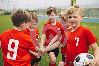 Kids on Football Soccer Team Putting Hands in. Boys Football School Team Huddling Stock Photo