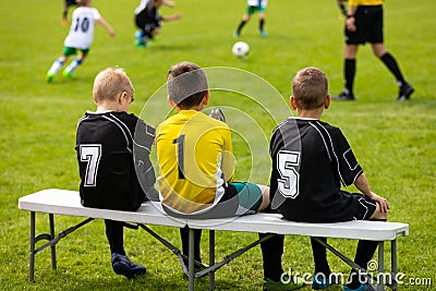 Kids Football Team. Young Soccer Players Sitting in a Row on a Wooden Bench Editorial Stock Photo