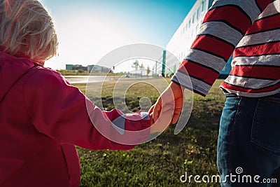 Kids friendship- boy and girl holding hands in the city Stock Photo