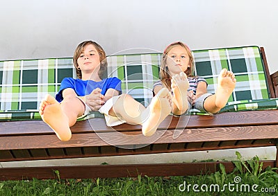 Kids on a garden swing Stock Photo