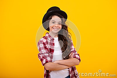 Kids girl in old fashion clothes. Elegent hat, cylinder hat isolated on yellow background. Headwear. Clothes accessories Stock Photo