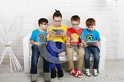 Kids in glasses with gadgets, computer addiction Stock Photo