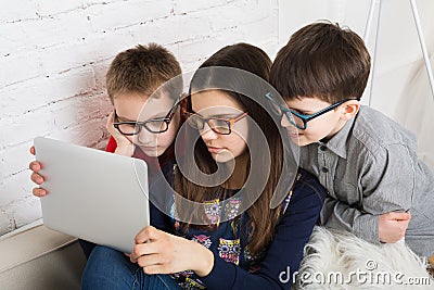 Kids in glasses with tablet, computer addiction Stock Photo