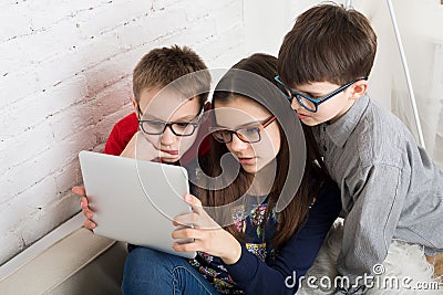 Kids in glasses with tablet, computer addiction Stock Photo