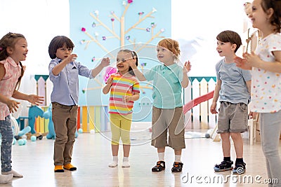 Kids group have fun and play at kindergarden Stock Photo