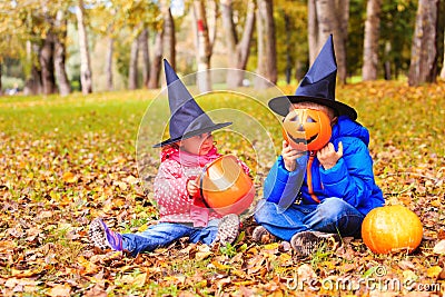 Kids in halloween costume play at autumn park Stock Photo