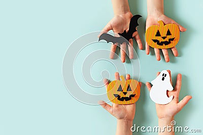 Kids halloween handmade paper pumpkins with childrens hands Stock Photo