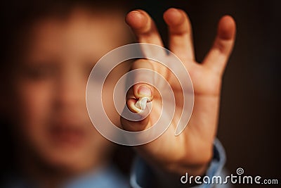 Kids Hand with one milk tooth. First tooth lost. Stock Photo