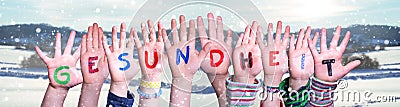 Kids Hands Holding Word Gesundheit Means Health, Snowy Winter Background Stock Photo