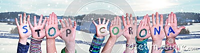 Kids Hands Holding Word Stop Corona, Snowy Winter Background Stock Photo