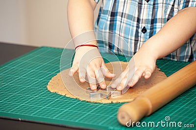Kids hands making dough cookies Stock Photo