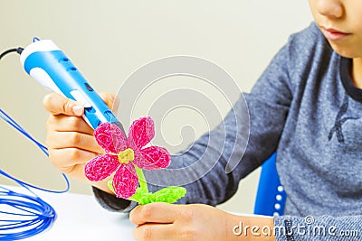Kids hands making flower with 3d printing pen Stock Photo