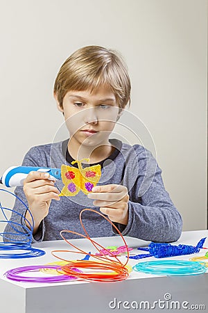 Kids hands making flower with 3d printing pen Stock Photo