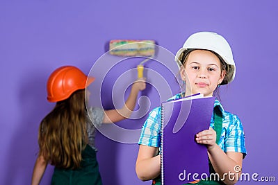 Kids happy renovating home. Repaint walls. Home improvement activity. Kids girls planning renovation. Violet is my Stock Photo