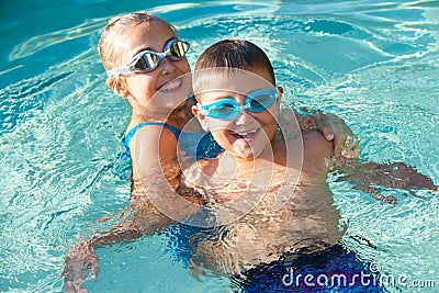 Kids having fun in swimming pool. Stock Photo