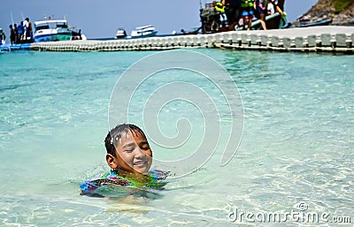 Kids having fun with playing water at the beach Editorial Stock Photo