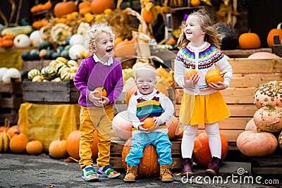 Kids having fun at pumpkin patch Stock Photo