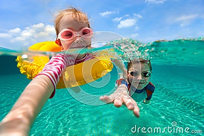 Kids having fun swimming on summer vacation Stock Photo