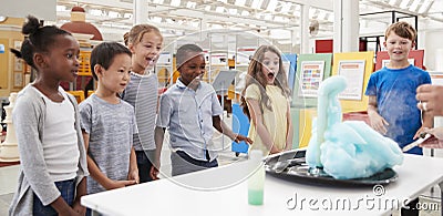 Kids having fun watching an experiment at a science centre Stock Photo