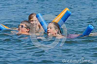 Kids having summer fun swimming in lake Stock Photo