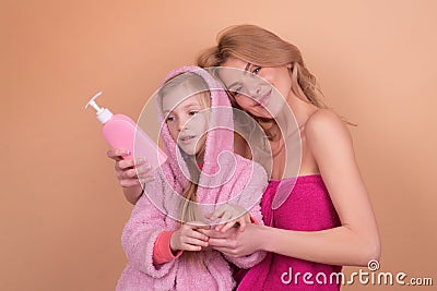 Kids hygiene equipment. Bath time. Mother with daughter in bathroom. Liquid Soap, Accessorizes for Bath, Shower and Stock Photo