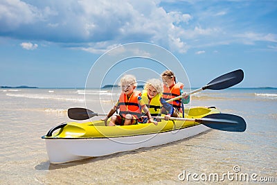 Kids kayaking in ocean. Children in kayak in tropical sea Stock Photo