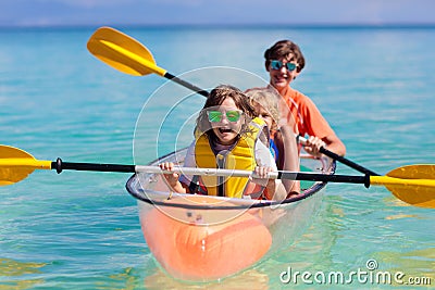 Kids kayaking in ocean. Family in kayak in tropical sea Stock Photo