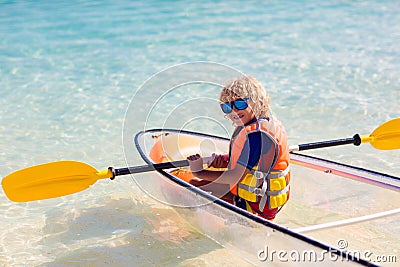 Kids kayaking in ocean. Family in kayak in tropical sea Stock Photo