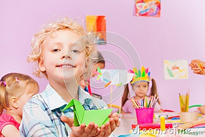 Kids in kindergarten make origami, portrait of boy Stock Photo