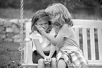 Kids kissing in summer park outdoors. Little boy and girl kids enjoying summer. Best friends two children. Stock Photo