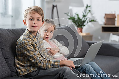 Preschooler children sitting on a sofa Stock Photo