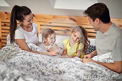 Kids like to sneak into a parent`s bed. Family, home, together Stock Photo