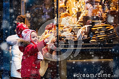 Kids looking at candy and pastry on Christmas market Stock Photo