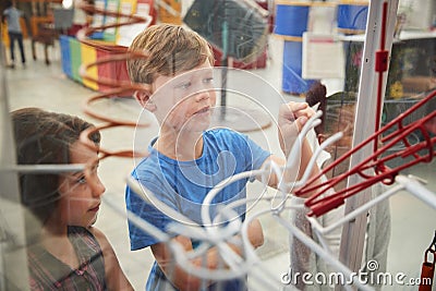 Kids looking through glass at a science exhibit, close up Stock Photo
