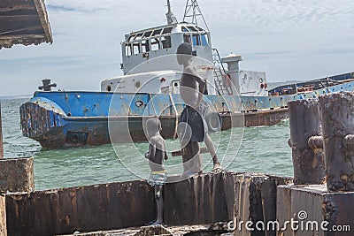 Kids looking old ship in Angola Editorial Stock Photo