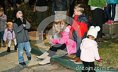 Kids looking at phone and playing at Christmas lighting ceremony in Tulsa Oklahoma USA 11-23-2017 Editorial Stock Photo